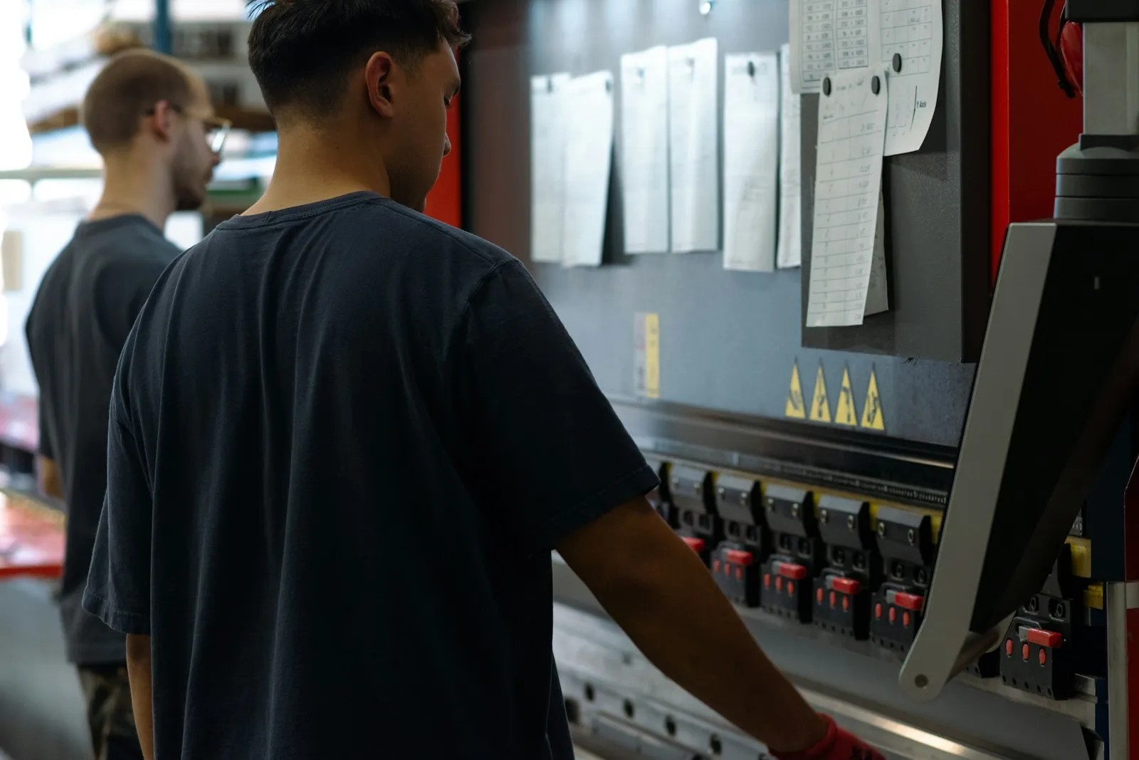 Operator working at a press brake in a sheet metal shop