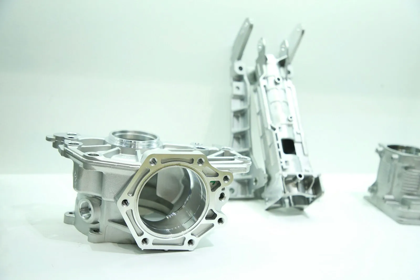 Machined aluminum housings on a white table