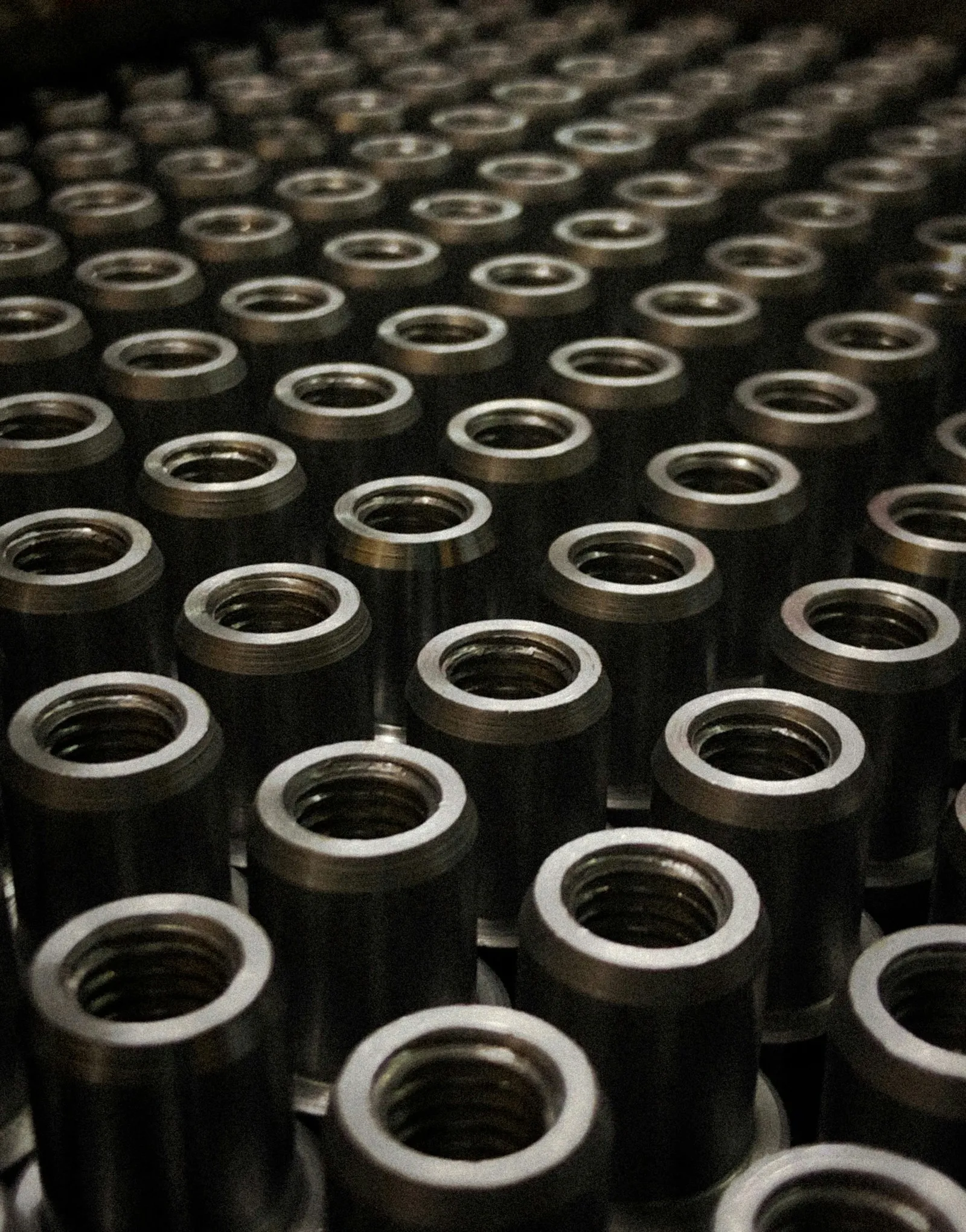 Rows of machined round metal bushings