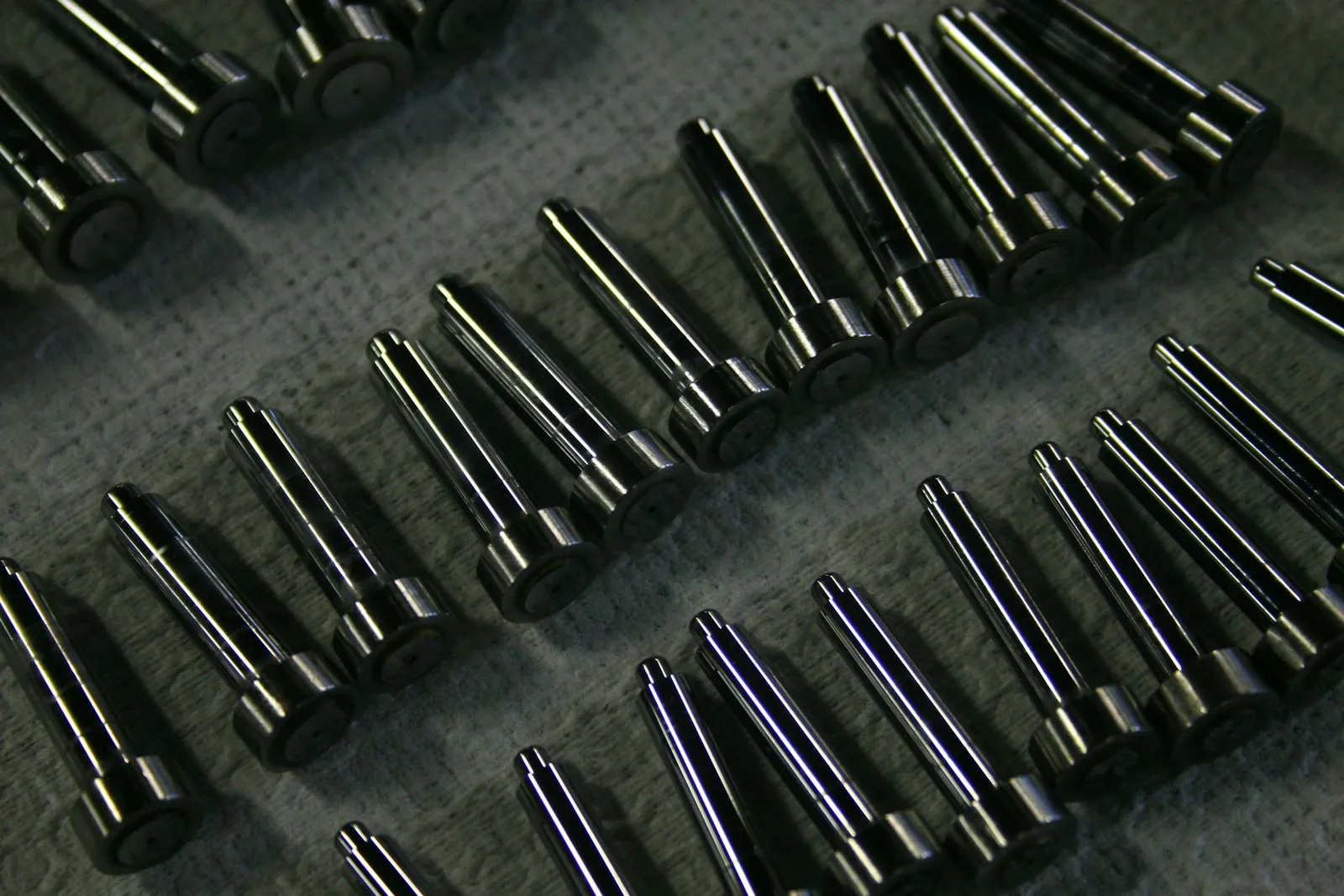 Rows of turned steel pins with shoulders on a cloth