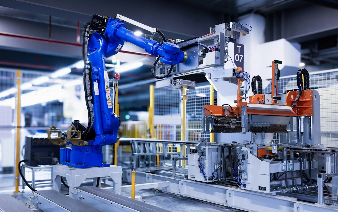 Blue industrial robot arm on an automated line